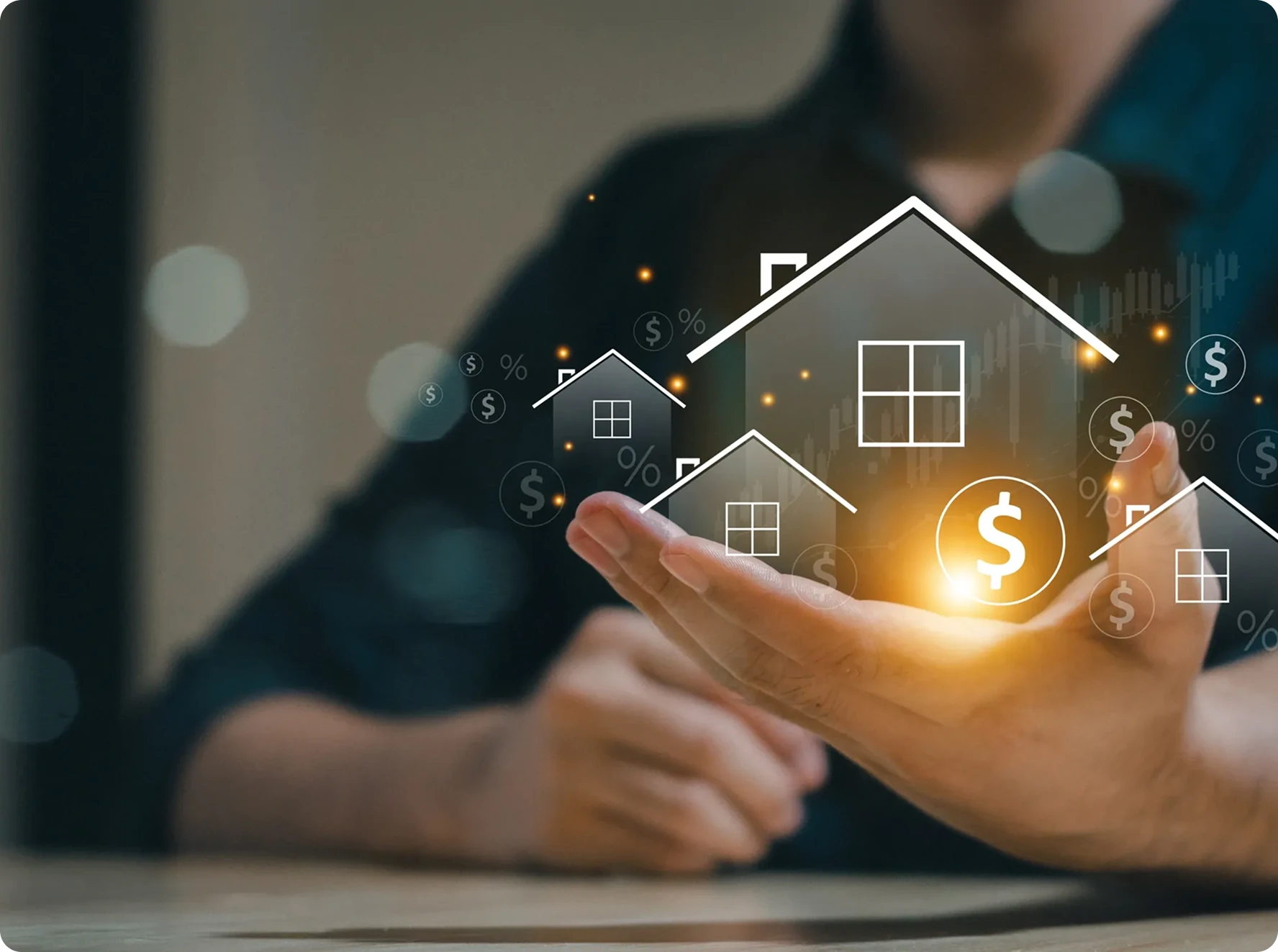 A person holds out their hand with digital icons of houses and dollar signs floating above it, symbolizing real estate investment or property value.